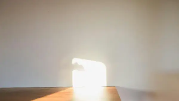 a room with a wooden floor and a white wall