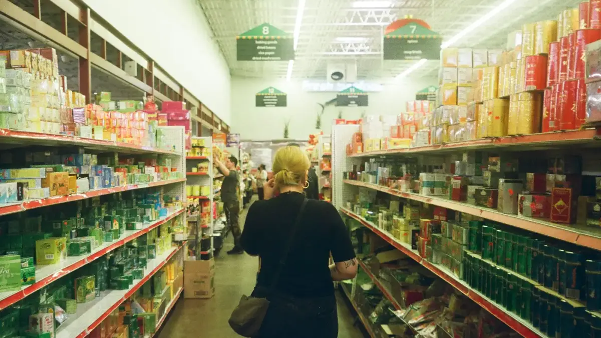 woman in black long sleeve shirt standing near white shelf