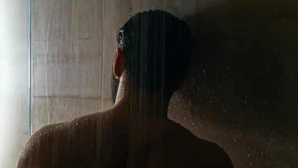 woman in black hair in front of white curtain