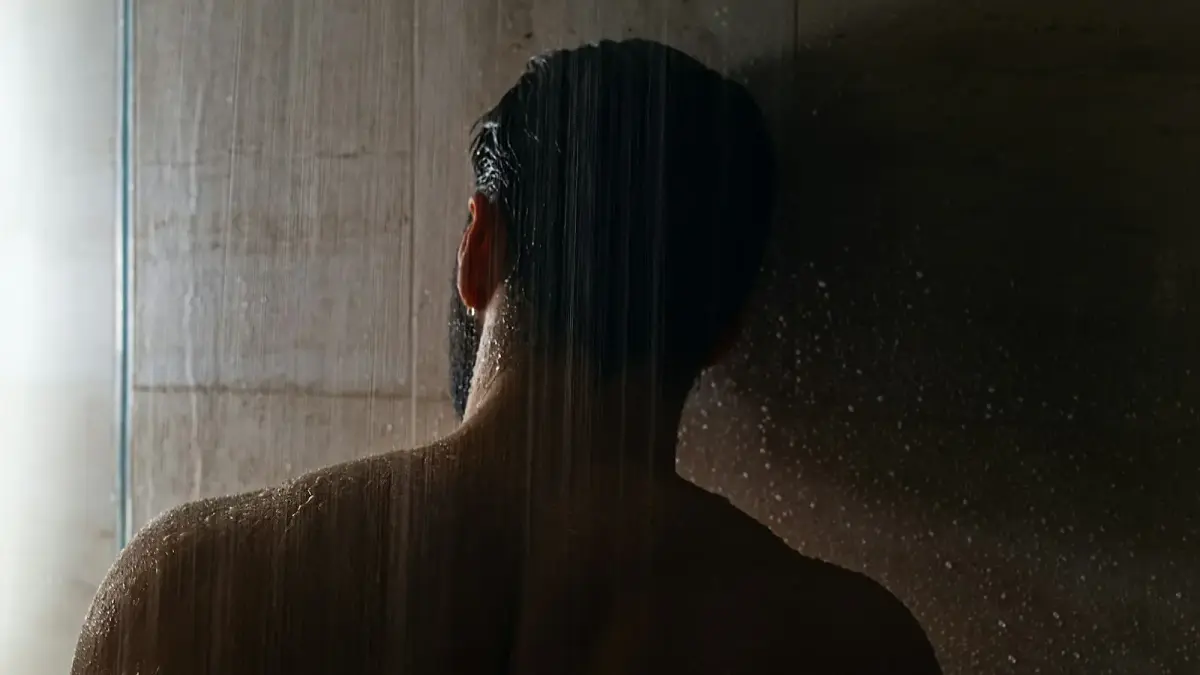 woman in black hair in front of white curtain
