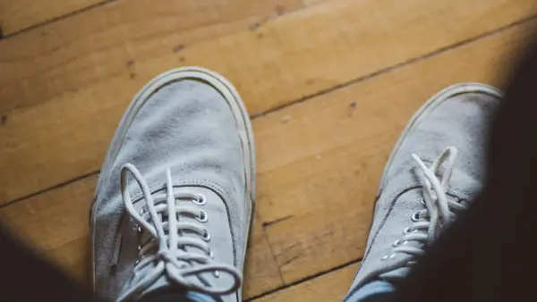 A person standing on top of a wooden floor