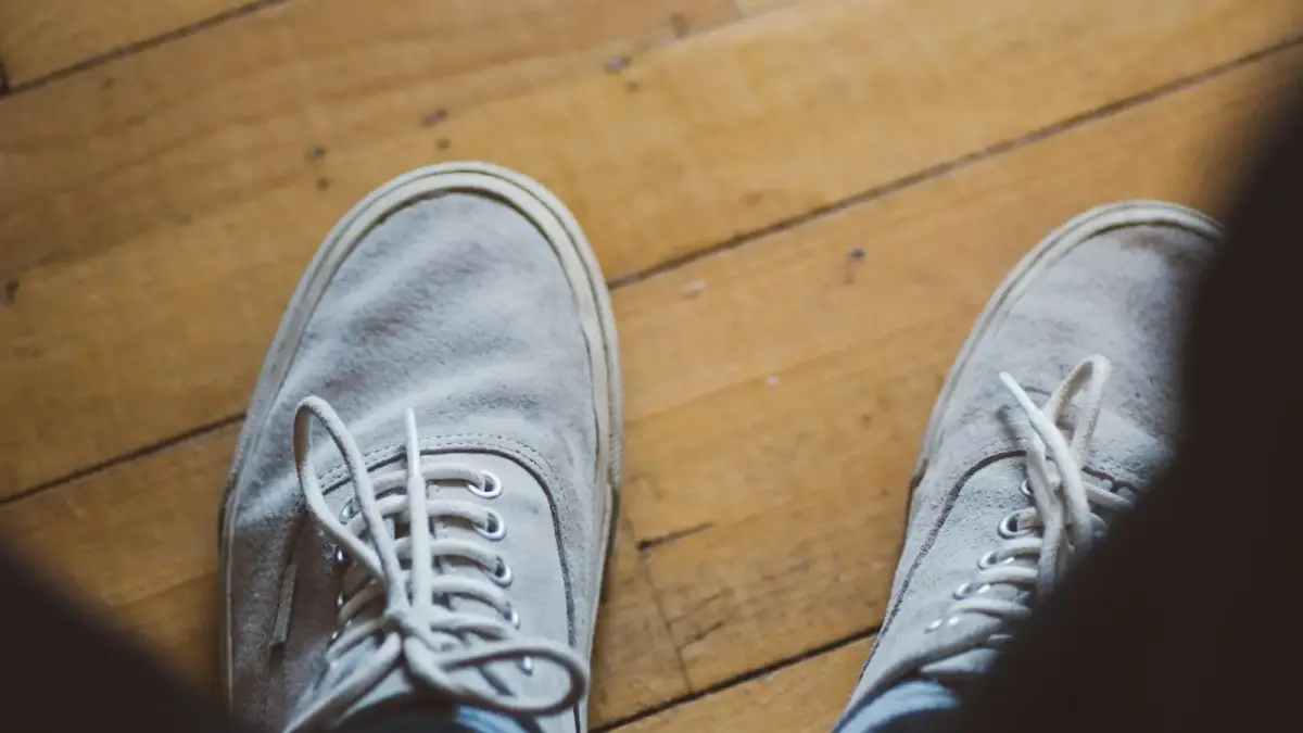 A person standing on top of a wooden floor