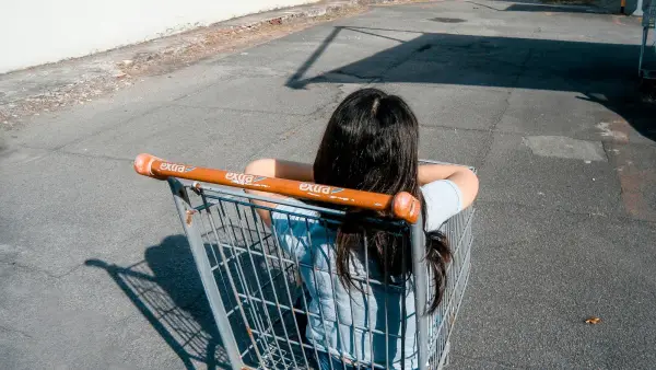 girl in gray grocery cart
