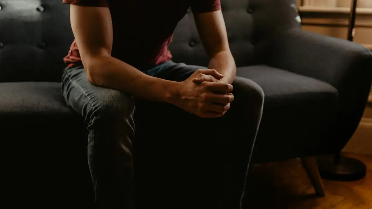 man sitting on sofa