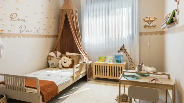 Cozy child's bedroom with bed and desk.