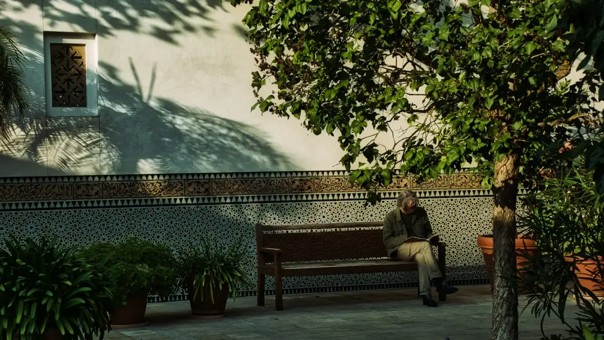 man and woman sitting on brown wooden bench