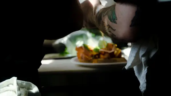 person with green and black tattoo on arm