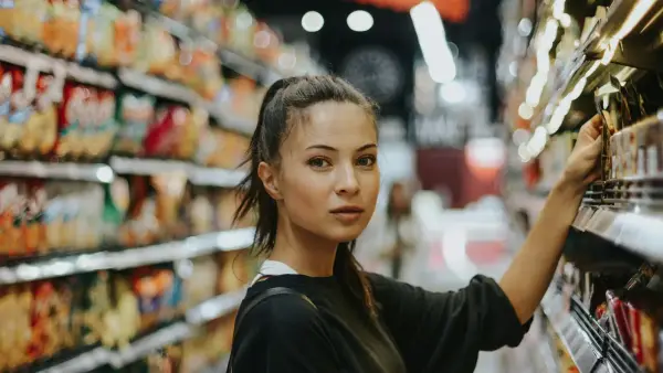 woman shopping in grocery store aisle