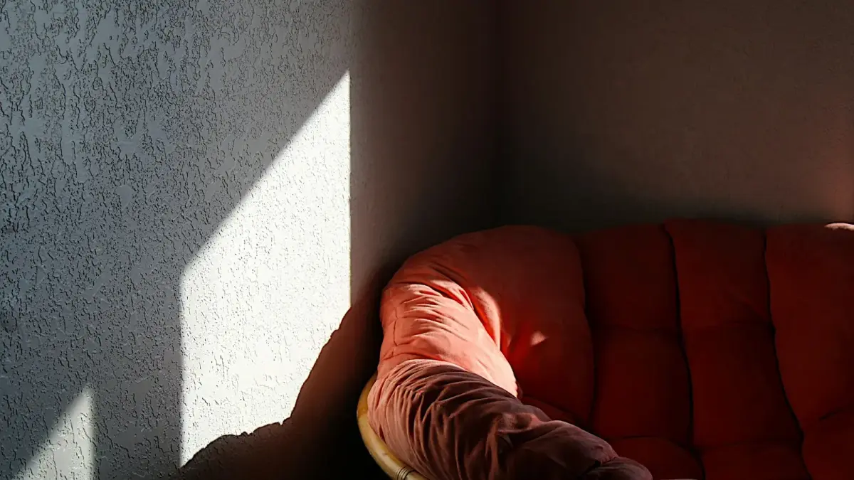 a red chair sitting in the corner of a room