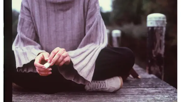 A person sitting quietly, lost in thought before speaking