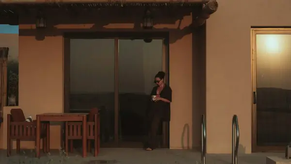 Woman standing on patio with coffee cup