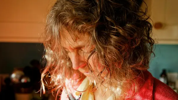 A close up of a person wearing a red shirt