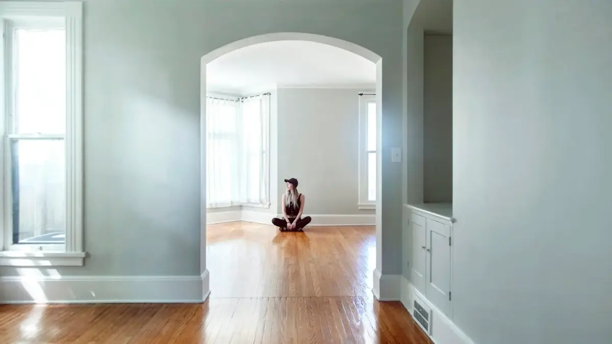 brown short coated dog on brown wooden parquet floor