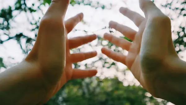 persons hand with water droplets