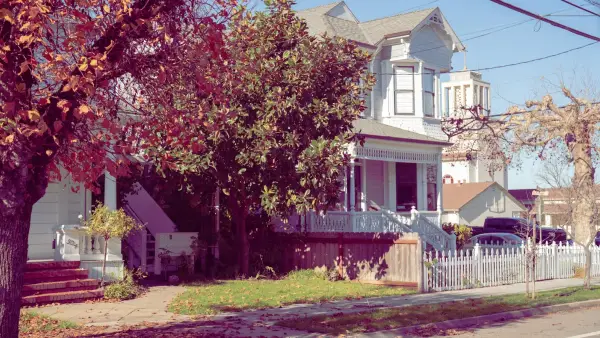 Victorian house with a white picket fence.