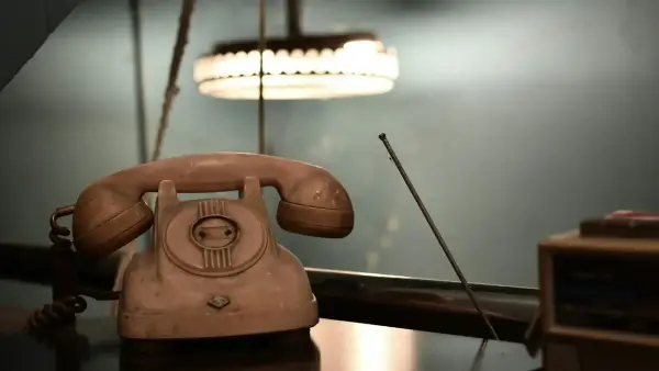 brown rotary telephone on brown wooden table