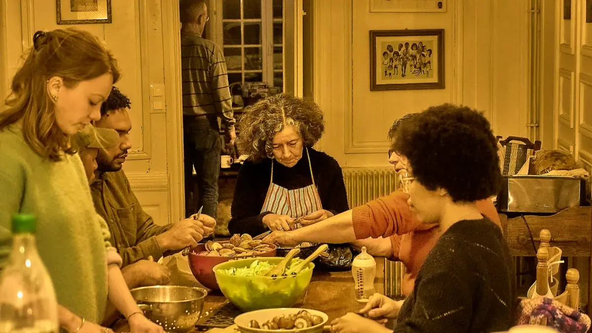 People gathered around a table preparing food together