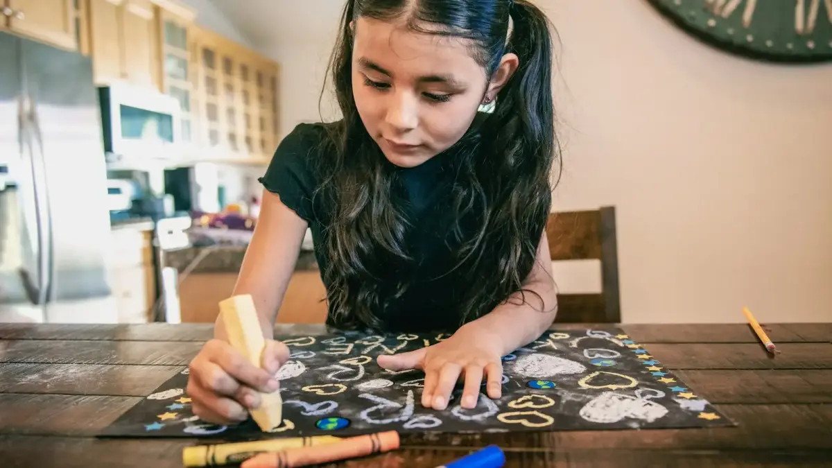 a young girl sitting at a table drawing with crayons