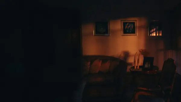 Dimly lit living room with framed art on wall