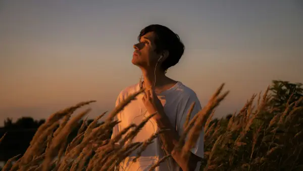 a man standing in a field of tall grass