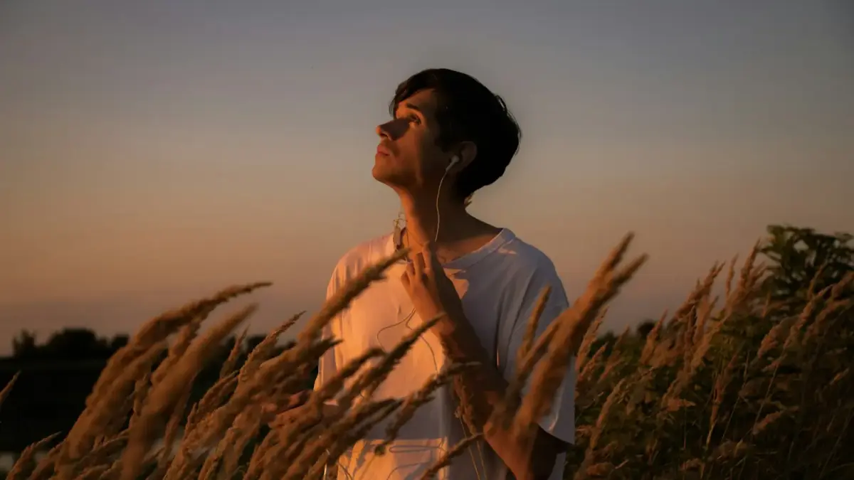a man standing in a field of tall grass