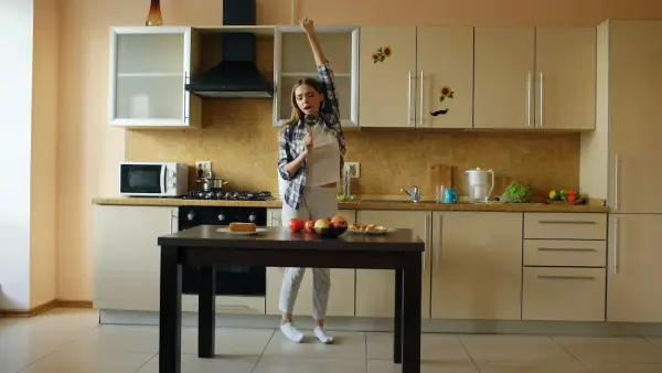 Young woman dancing in a modern kitchen