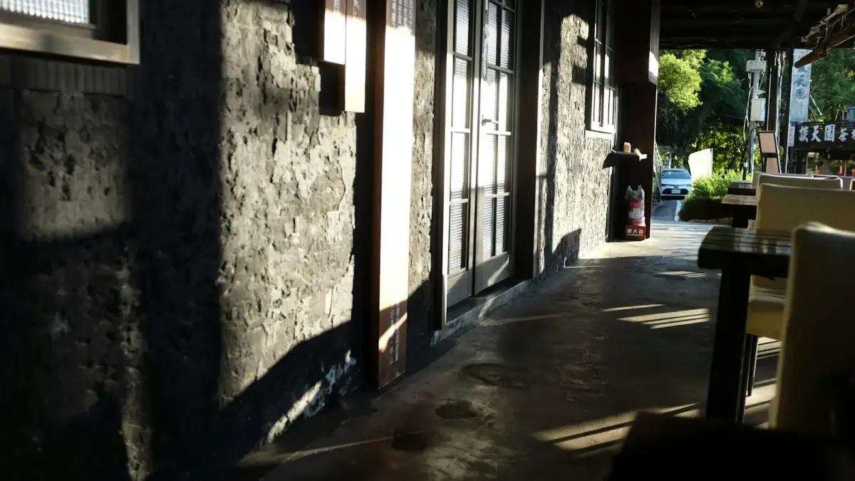 Sunlight streams across a textured wall and patio