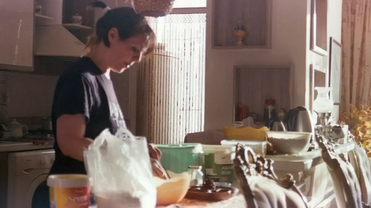 Woman is preparing something in the kitchen.