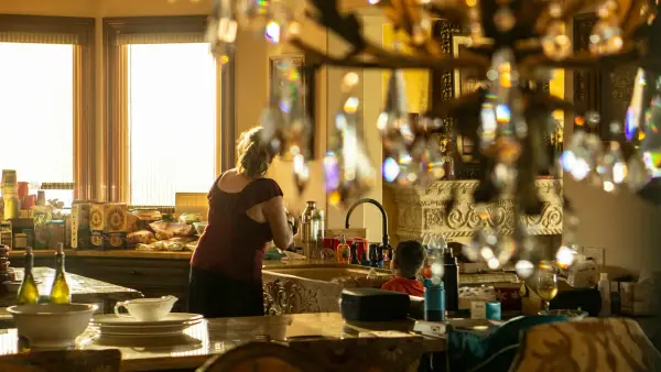 woman in black shirt standing in front of table