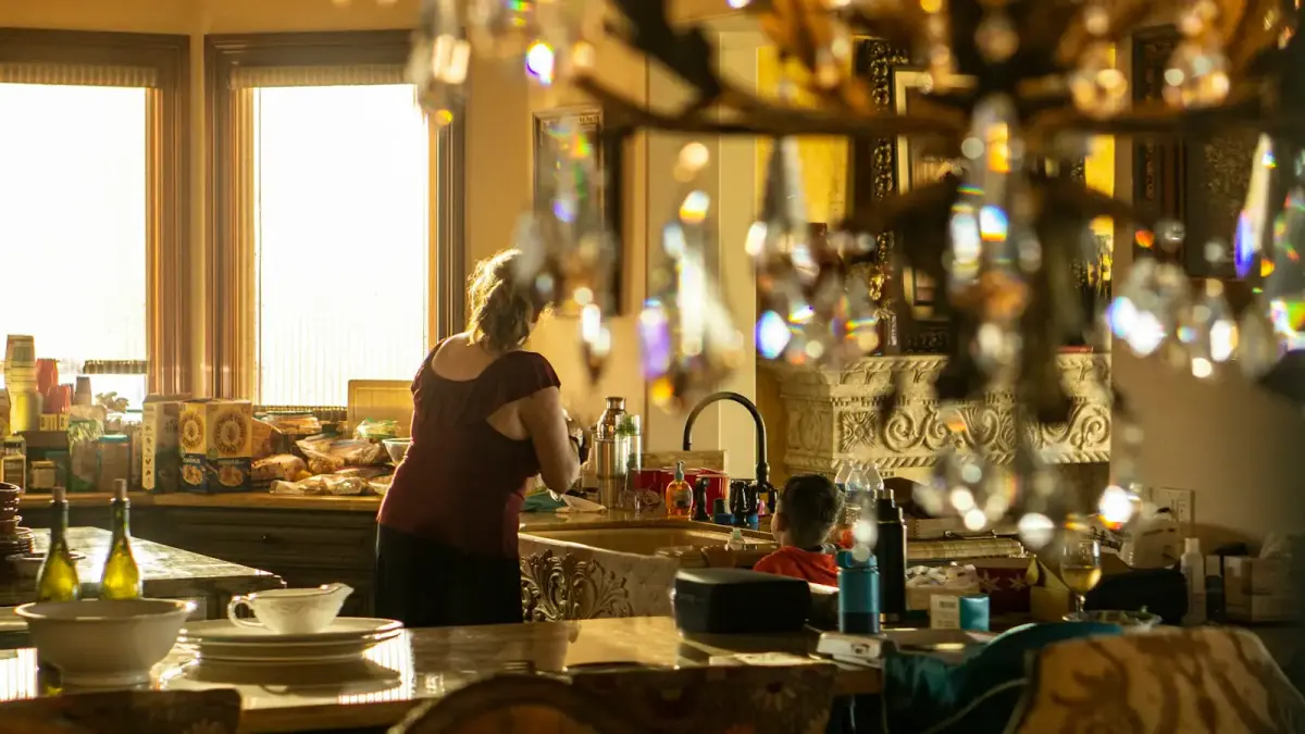 woman in black shirt standing in front of table