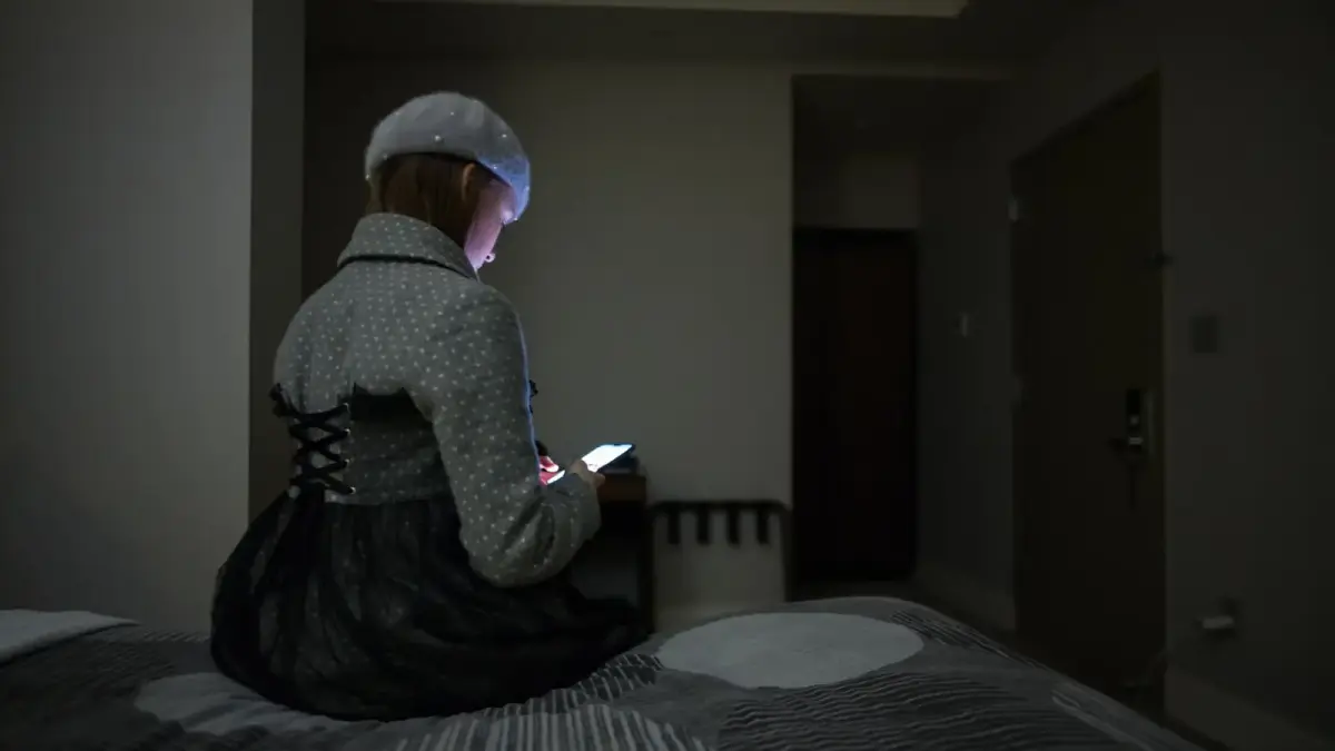 woman sitting on bed