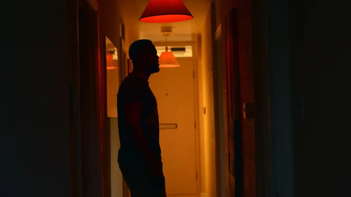 a man standing in a hallway at night
