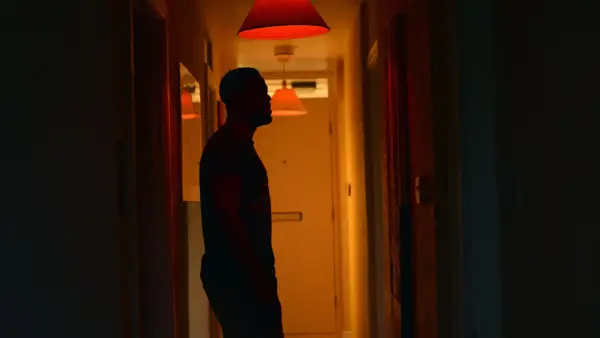 a man standing in a hallway at night