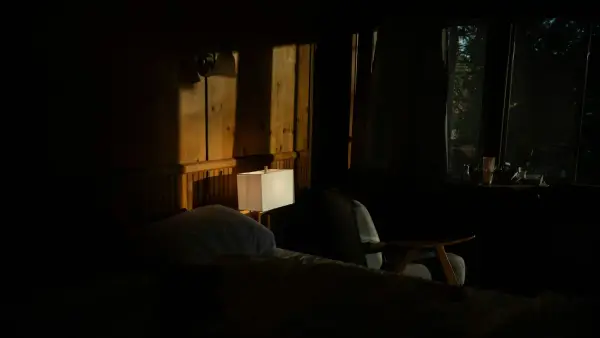 Dimly lit bedroom with sunlight through window