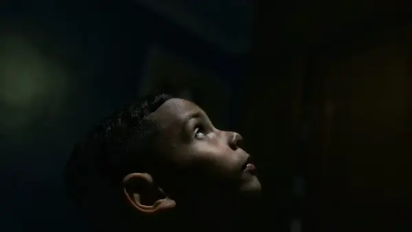 a boy looking up at a light