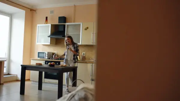 Woman talking on phone in a kitchen