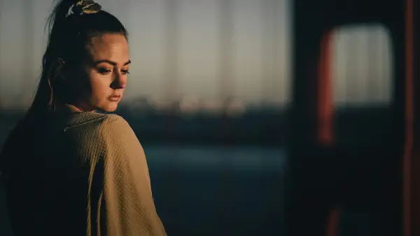 a woman standing in front of a window