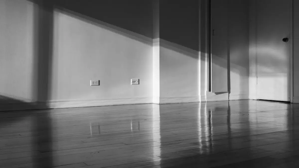 a black and white photo of a room with a door