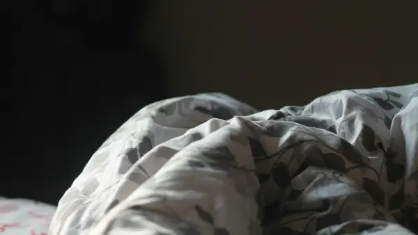 Close up of a folded blanket with a floral pattern.