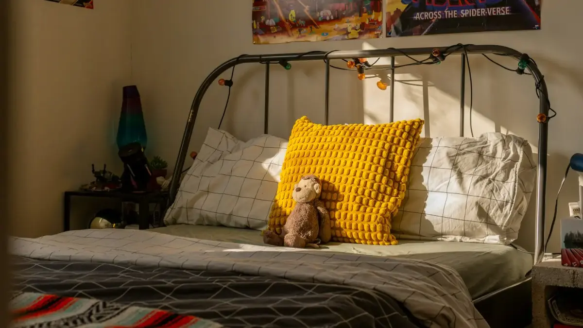 A child's bedroom with a bed and posters