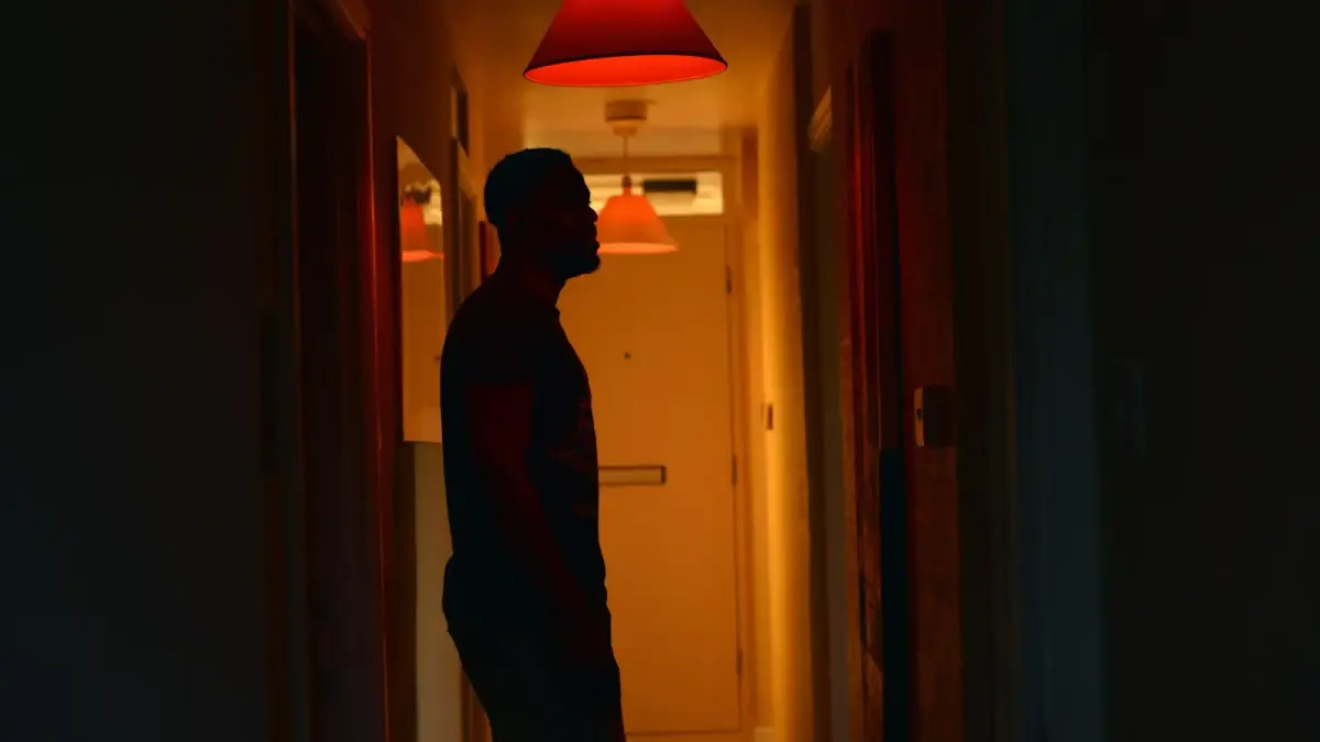 a man standing in a hallway at night