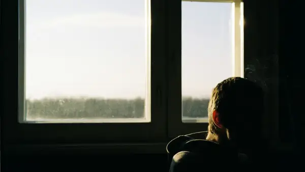 a person sitting in front of a window