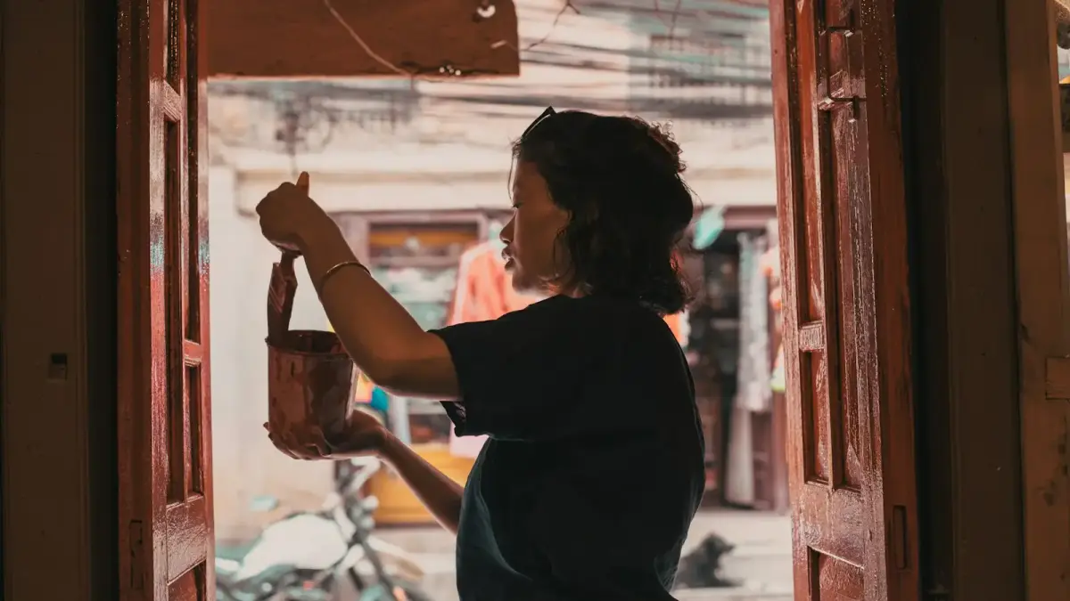 Woman holding a small leather bag indoors