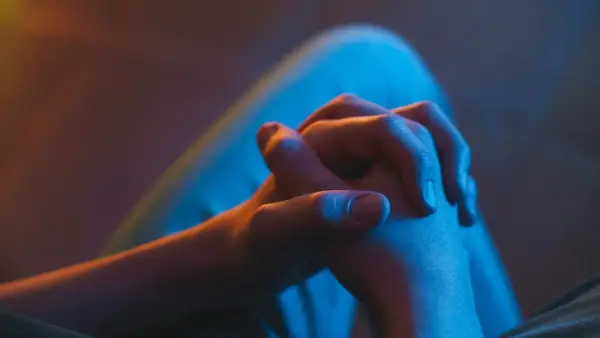 a woman's hands resting on a couch