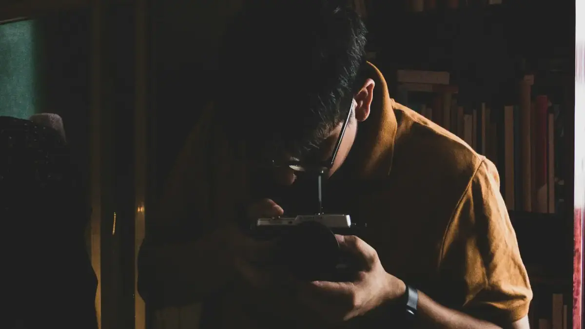man in brown shirt holding smartphone