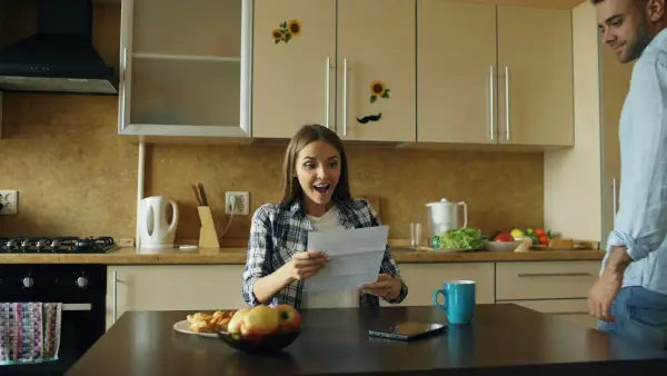 Couple reacts to good news in kitchen