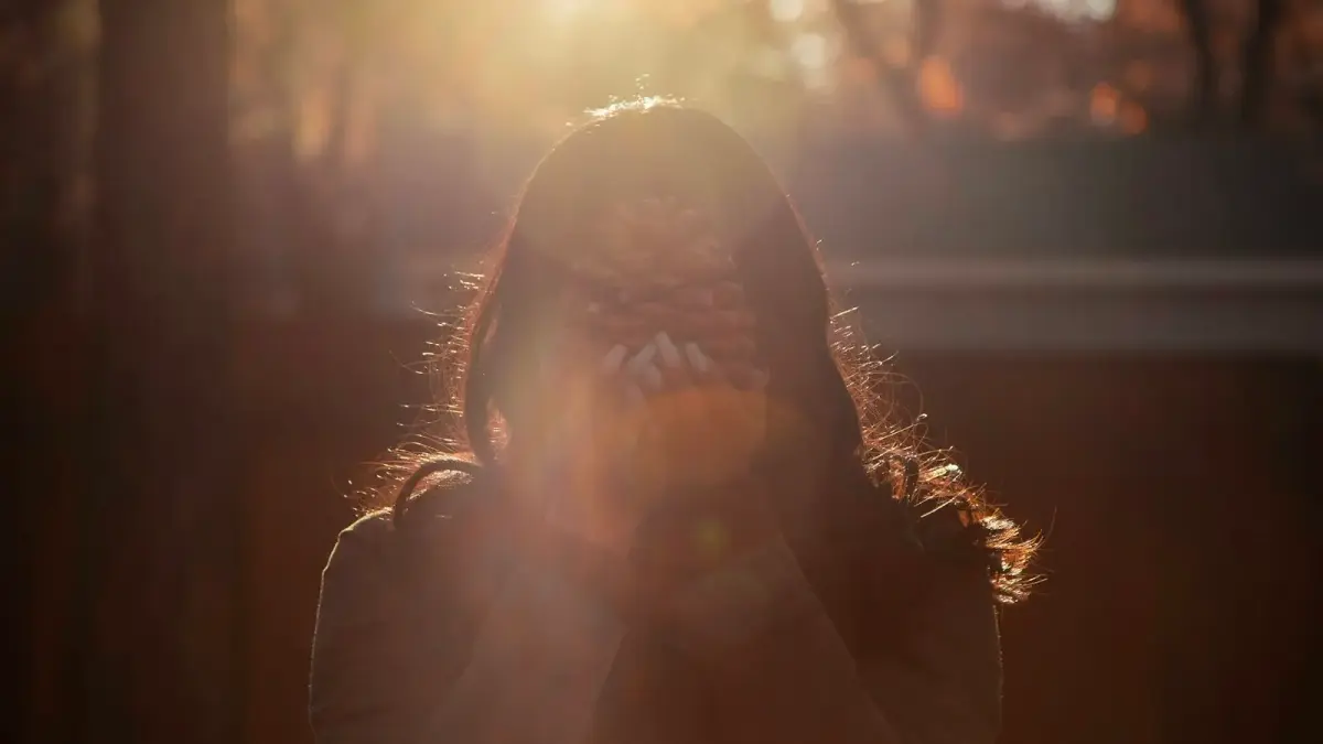 woman holding pine cone