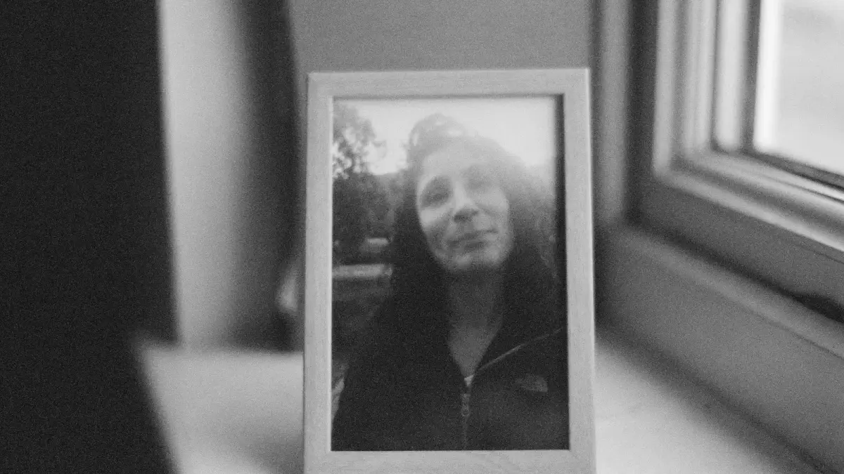 grayscale photo of woman in white frame