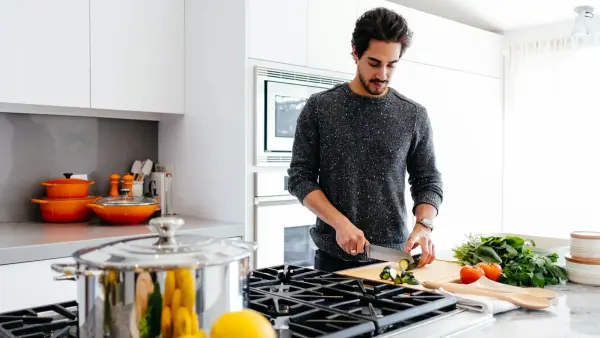 man cutting vegetables