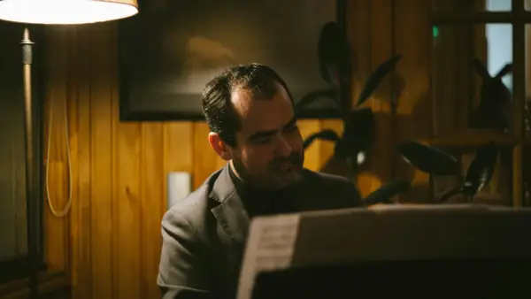 A man sitting at a computer in a room